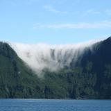 Clouds pouring over a mountain
